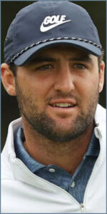 A golfer wearing a blue cap and white jacket, focused and engaged